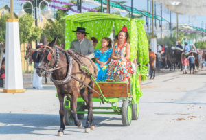People wearing traditional dresses riding on a carriage, Malaga Festival, Malaga, Andalusia, Spain, People wearing traditional dresses riding on a carriage, Malaga Festival, Malaga, Andalusia, Spain,